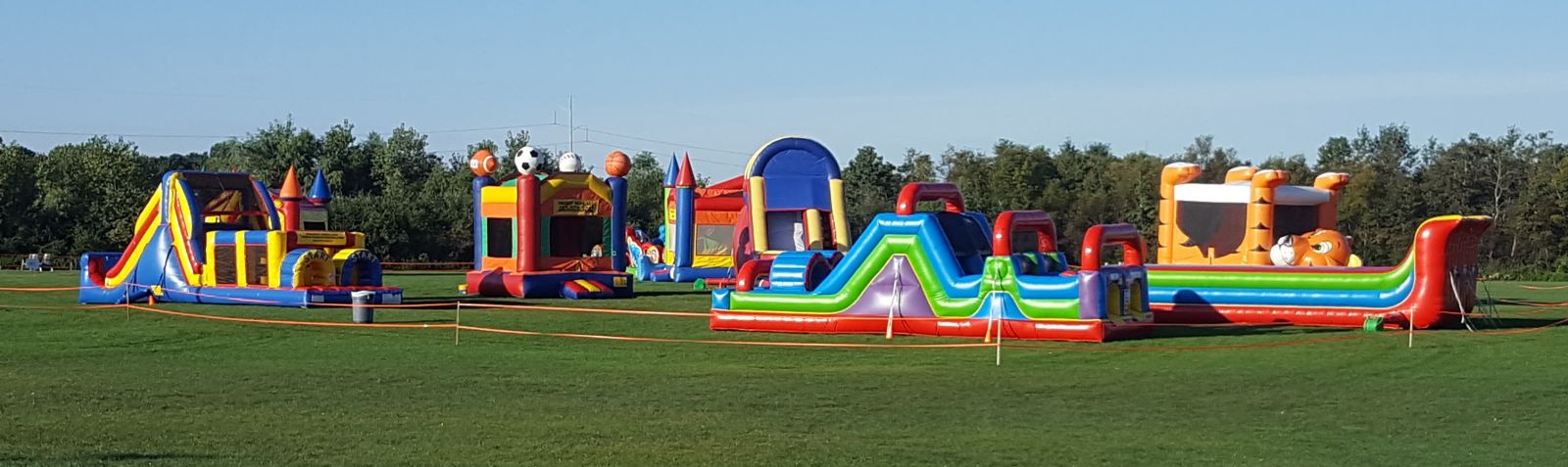 Sports Bounce house and other inflatables at field event by Froggy Hops